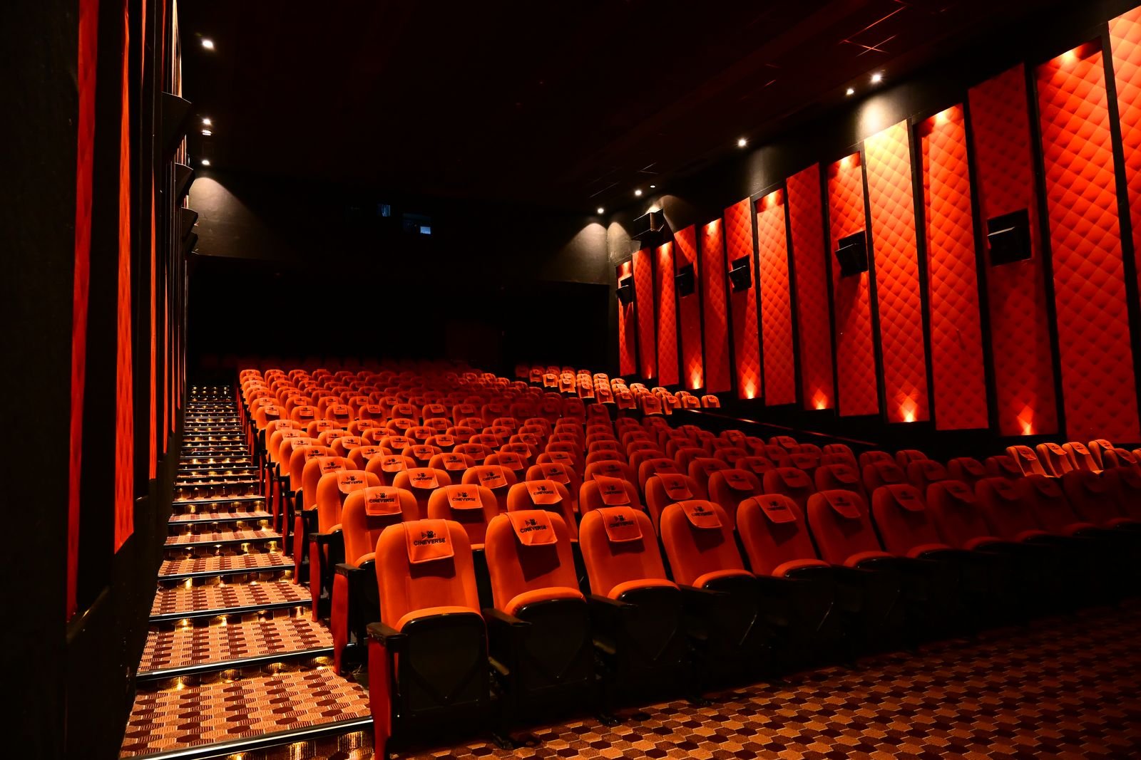 Wall-mounted surround speakers along the acoustic panelling of a Cineverse Multiplex auditorium
