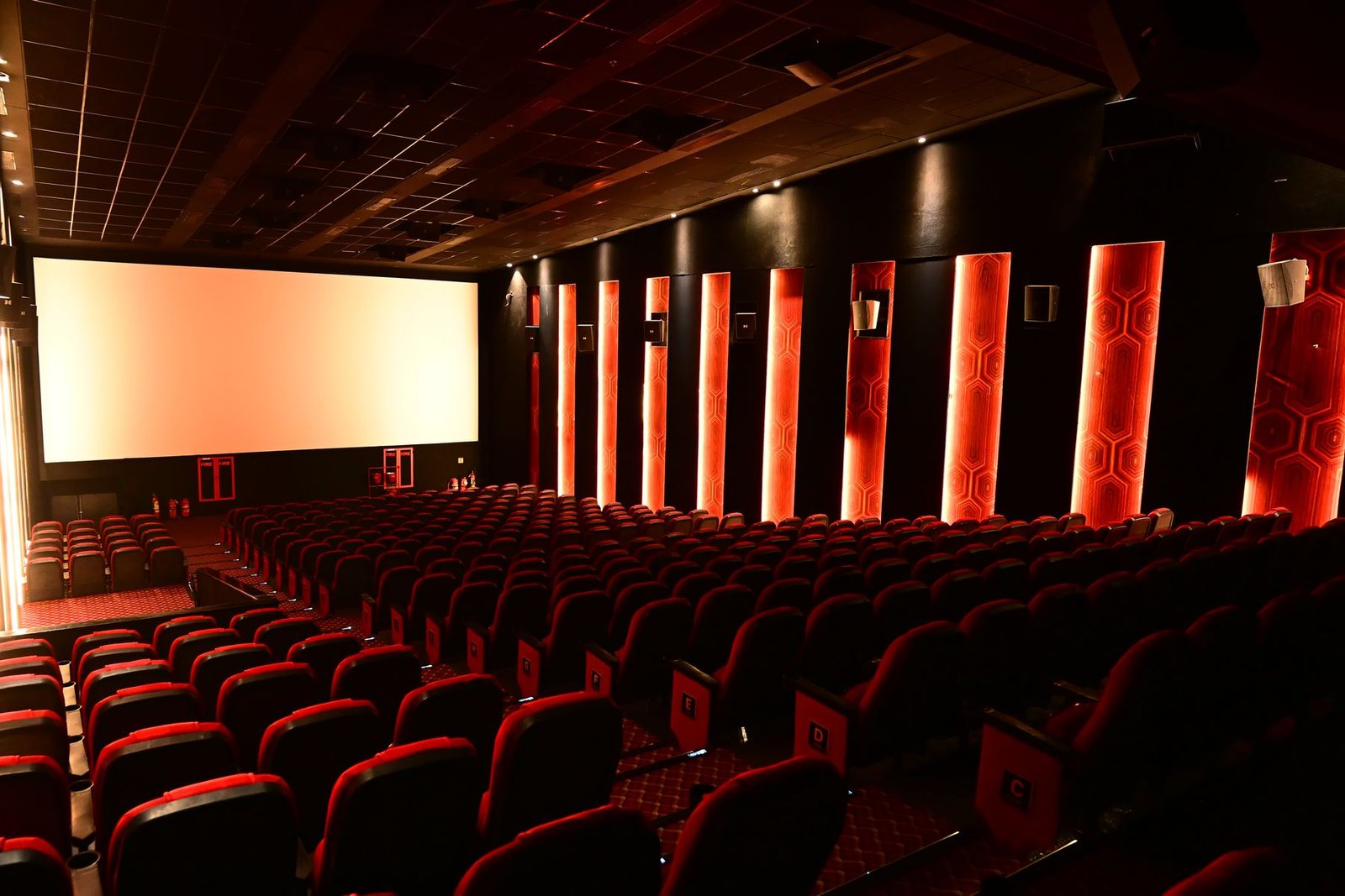 A Cineverse Multiplex auditorium, screen lit and ready