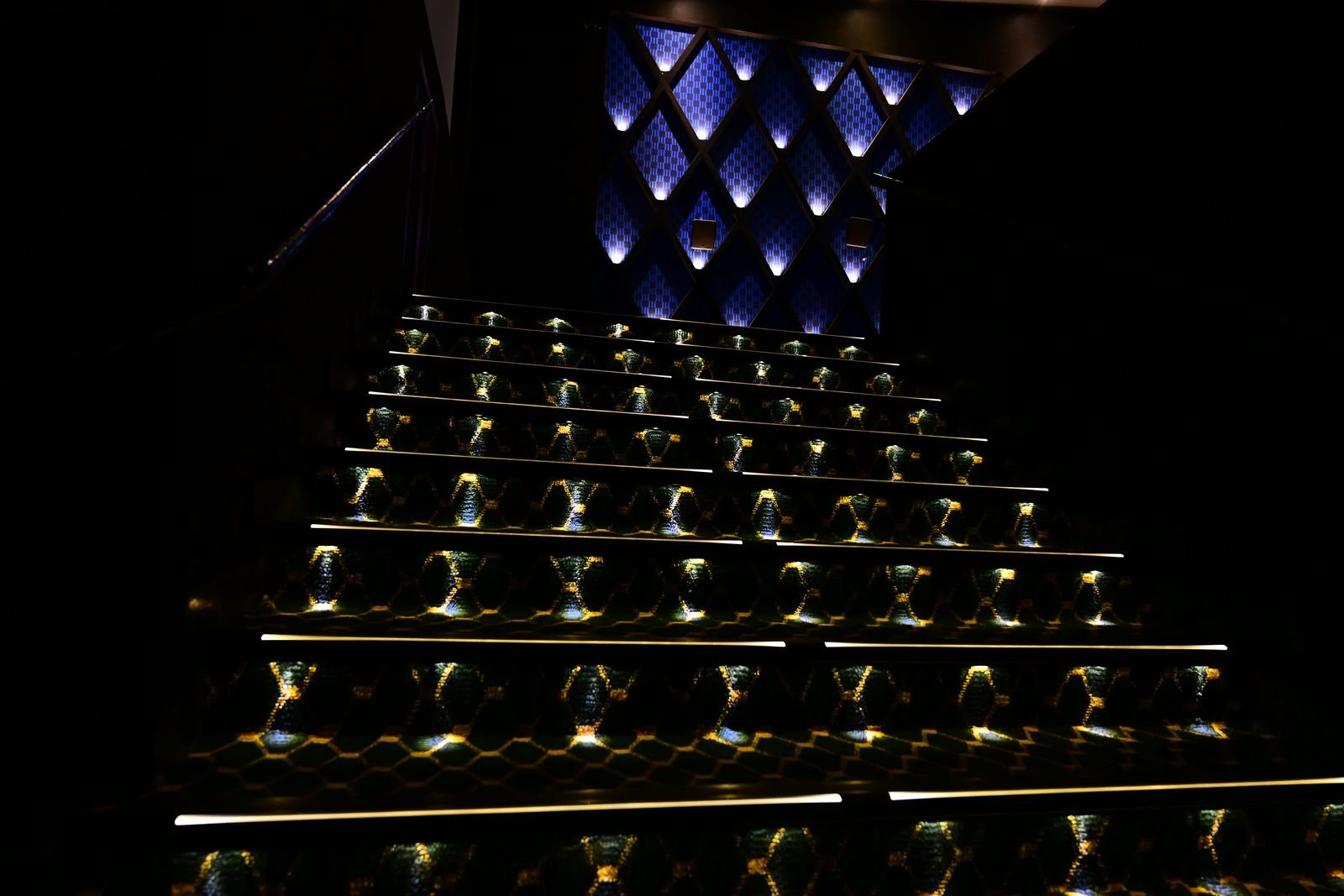 Illuminated step nosings running up a darkened auditorium aisle